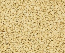 A close-up view of many small, irregularly shaped, pale yellow granules or pieces, densely packed together and covering the entire image.