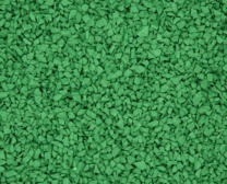 Close-up of a green rubber playground or athletic track surface, showing small, irregularly shaped pieces tightly packed together.