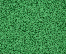 Close-up of a green rubber playground or athletic track surface, showing small, irregularly shaped pieces tightly packed together.