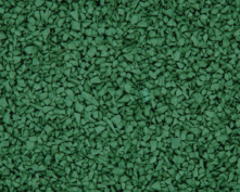 Close-up view of a textured green rubber surface, often used for playgrounds or athletic tracks, showing small, irregularly shaped rubber pieces tightly packed together.