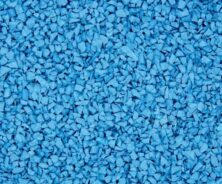 A close-up view of small, irregularly shaped blue rubber granules tightly packed together, forming a textured surface.