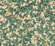Close-up of a surface covered with small, irregularly shaped rubber granules colored green and beige, often used for playground flooring or athletic tracks.