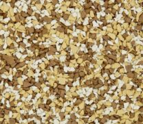 A close-up of a surface covered in small, irregularly shaped tan, brown, and white chips, resembling decorative gravel or textured flooring material.