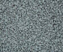 A close-up view of a textured surface covered with small, irregularly-shaped, light gray rubber or stone granules.