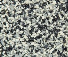 Close-up of a textured surface made of small, jagged rubber pieces in shades of black, white, and gray, resembling a speckled or granulated pattern.