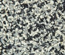 Close-up of a textured surface made of small, jagged rubber pieces in shades of black, white, and gray, resembling a speckled or granulated pattern.