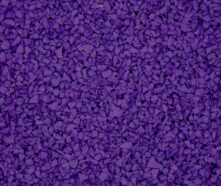 Close-up of a textured surface made up of small, irregular purple rubber pieces tightly packed together, resembling playground flooring or sports track material.