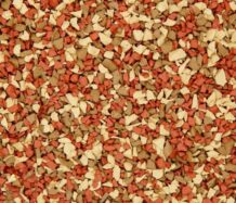 A close-up of small, irregularly shaped pieces in shades of beige, tan, and reddish-brown, densely packed together, resembling textured gravel or decorative landscape stones.