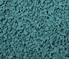 Close-up of teal-colored rubber granules or small pieces, often used for playground or sports flooring surfaces, showing an uneven and textured pattern.