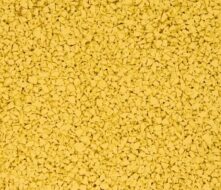 Close-up view of small, irregularly shaped yellow granules densely packed together, creating a textured surface.